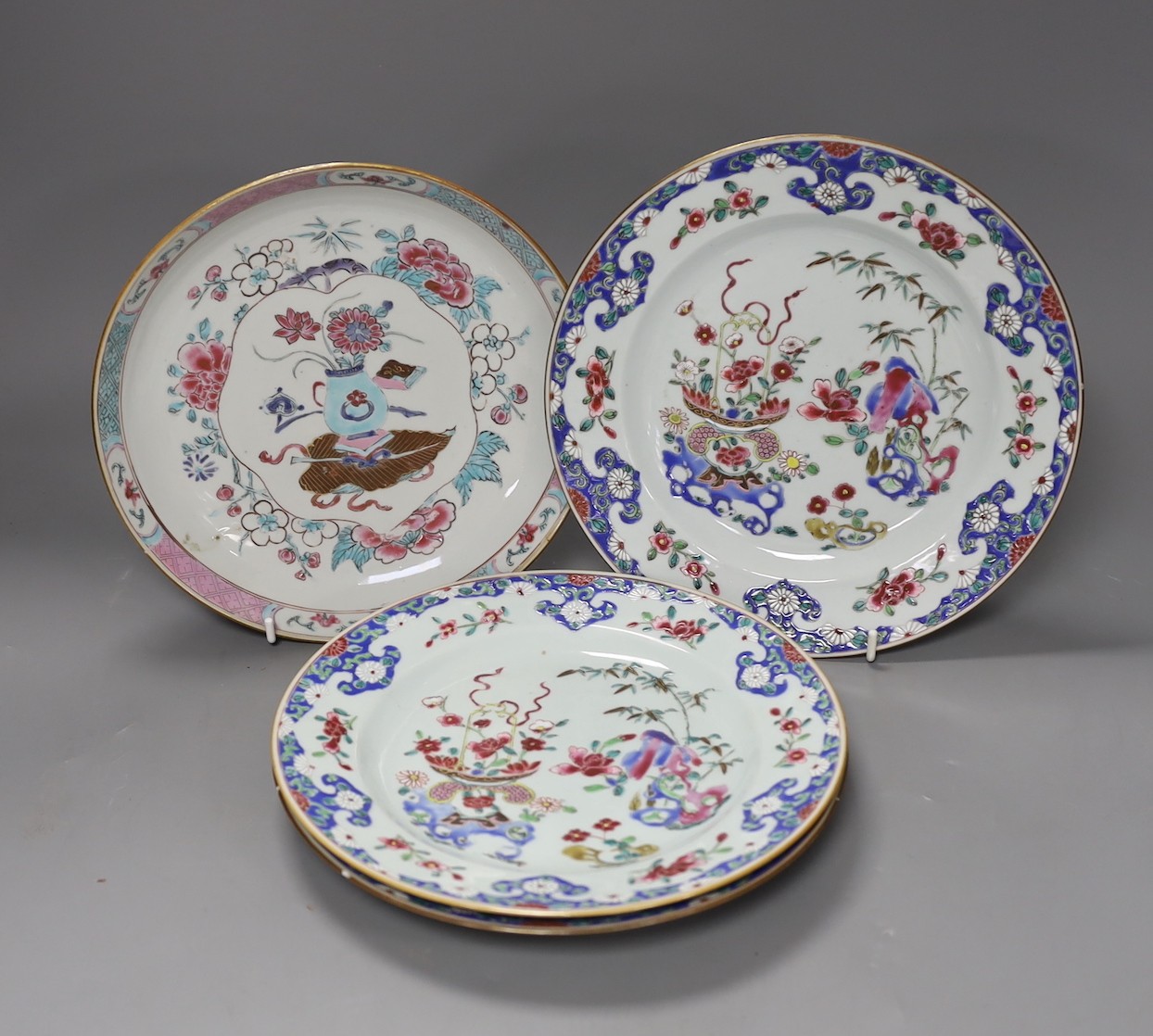 A Set of three 18th century Chinese export famille rose plates and a similar dish, largest 22.5cm diameter